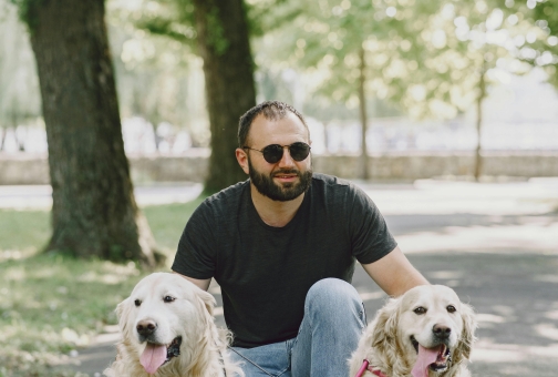 two guide dogs with owner walking in the park