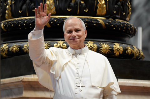 Pope waving to the people from inside the Vatican
