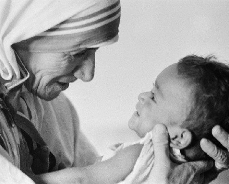 black and white of St Mother Theresa holding a baby in front of her
