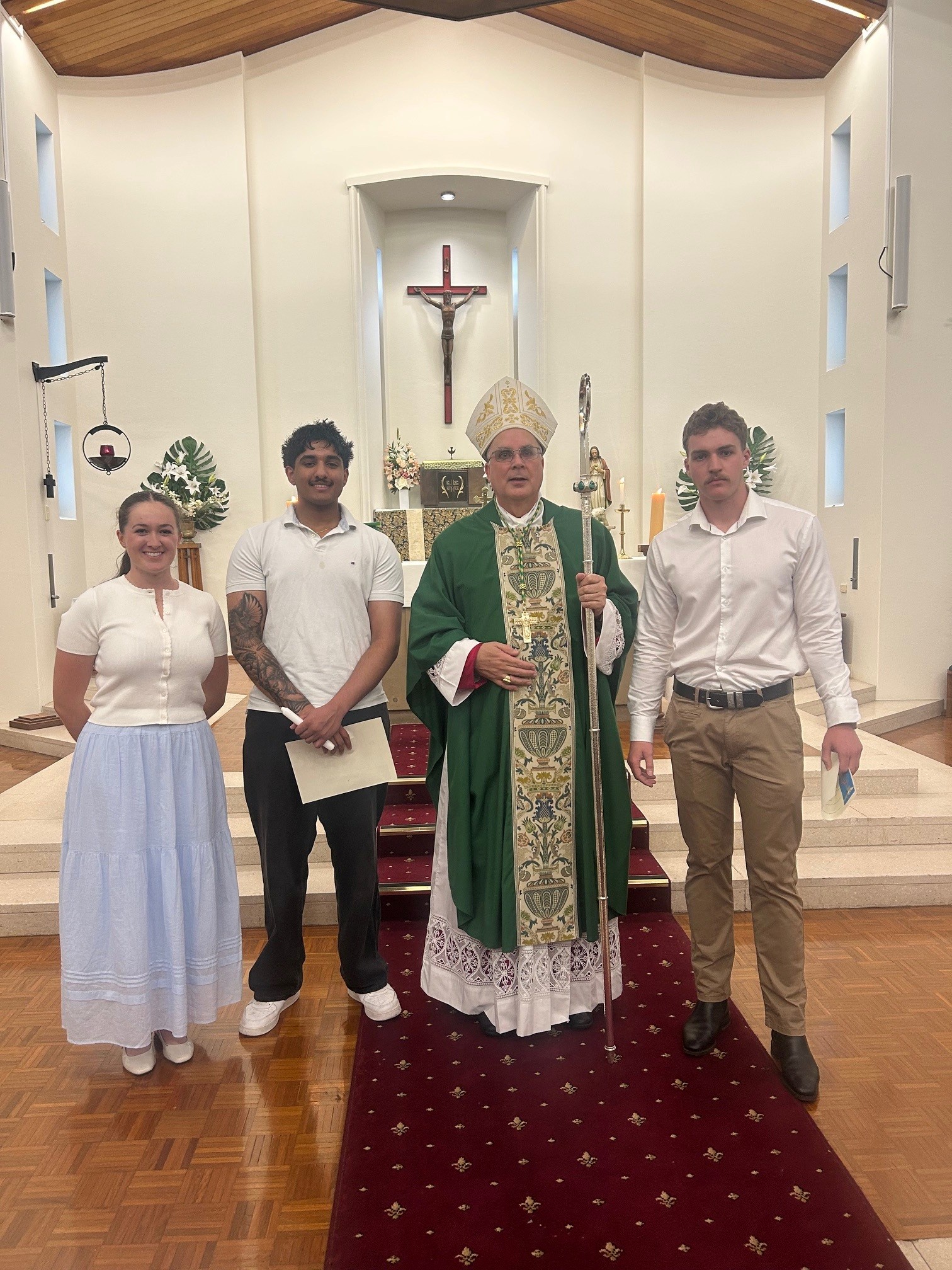 Left to right: Bridget, Ishveer, Bishop Stuat Hall, and 